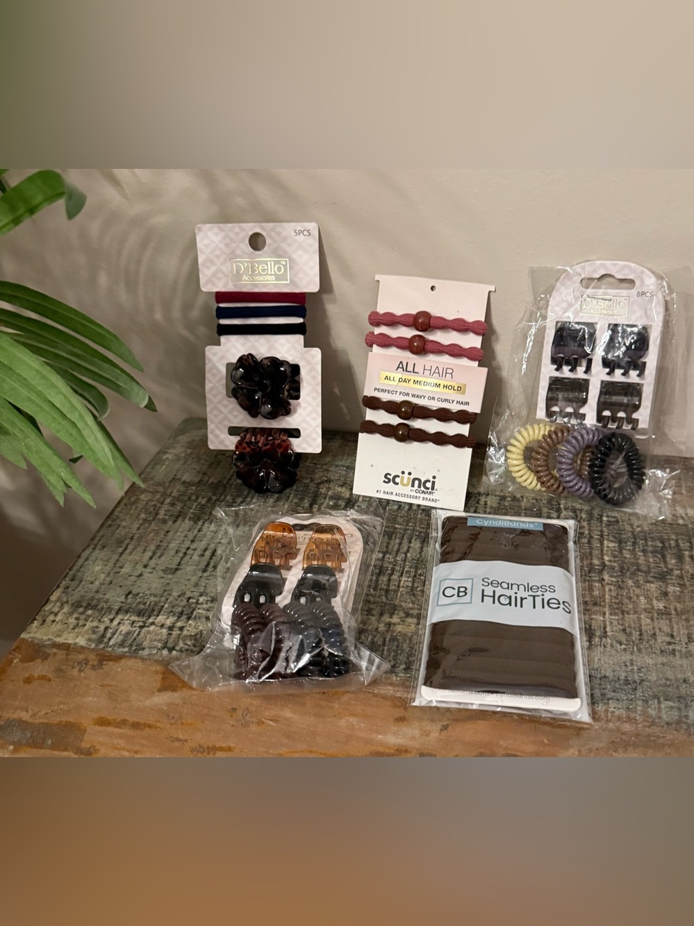 Five sets of packaged hair accessories. Set of 12 brown hair ties.